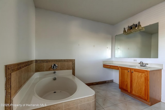 bathroom featuring baseboards, a garden tub, tile patterned flooring, and vanity
