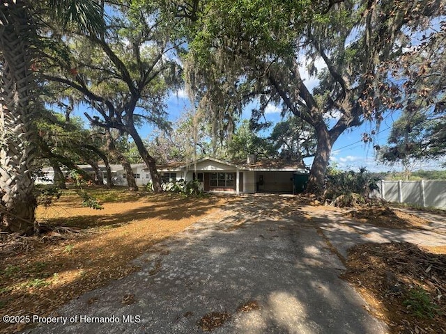 exterior space with fence and concrete driveway