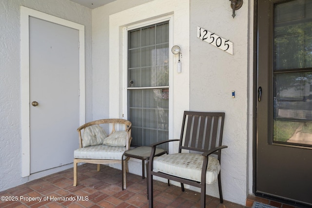 property entrance with stucco siding