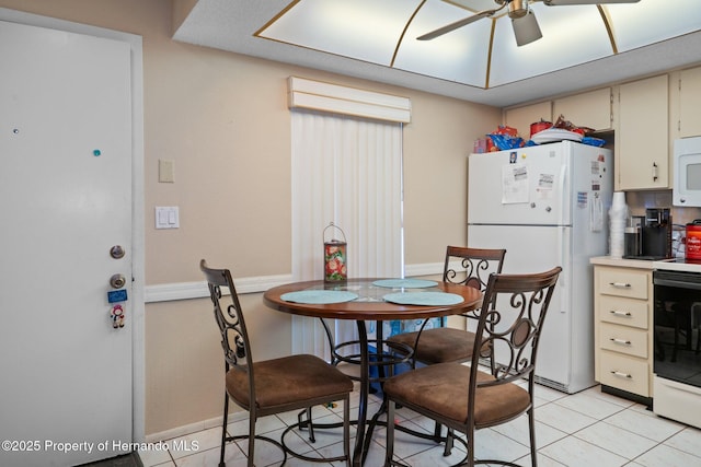 dining area with baseboards, a ceiling fan, and light tile patterned flooring