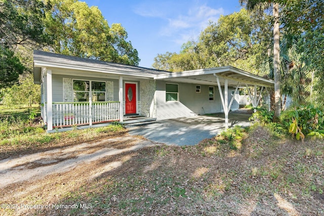 406 Zoller St, Brooksville, FL 34601 - view of front of property with covered porch, an attached carport, and dirt driveway