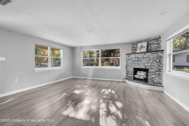 406 Zoller St, Brooksville, FL 34601 - unfurnished living room featuring wood finished floors, plenty of natural light, and visible vents