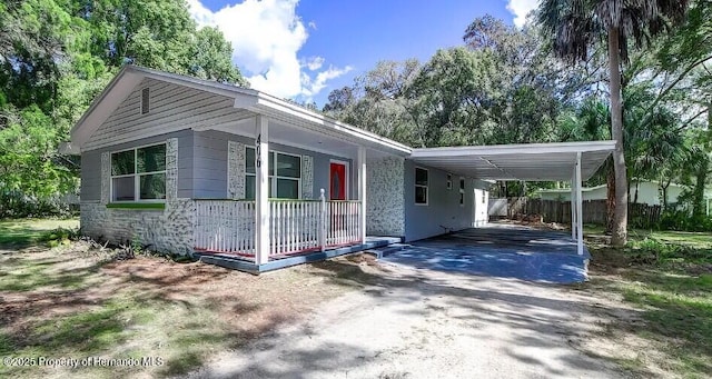 406 Zoller St, Brooksville, FL 34601 - view of property exterior featuring driveway, a carport, and a porch