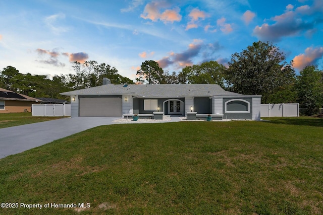 1156 Battersea Ave, Spring Hill, FL 34609 - single story home featuring fence, a garage, a front lawn, driveway, and french doors