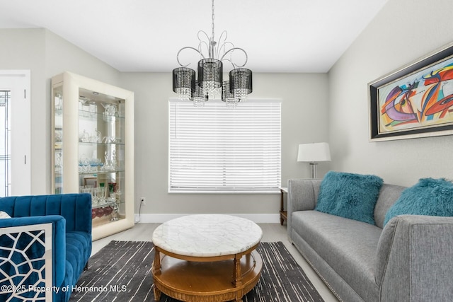 1156 Battersea Ave, Spring Hill, FL 34609 - living area featuring baseboards, a notable chandelier, and plenty of natural light