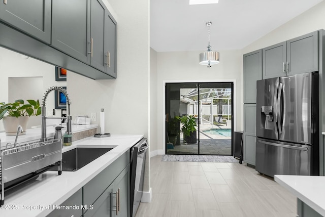 1156 Battersea Ave, Spring Hill, FL 34609 - kitchen featuring light countertops, hanging light fixtures, gray cabinetry, stainless steel appliances, and baseboards