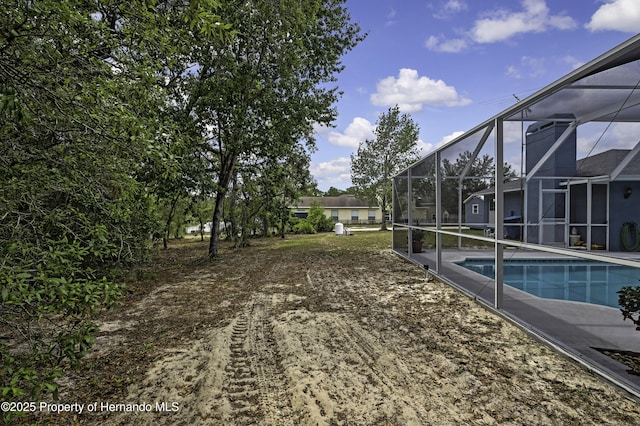 outdoor pool featuring glass enclosure