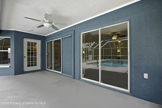 view of patio featuring a ceiling fan and an outdoor pool