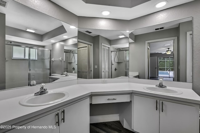 full bathroom with a shower stall, recessed lighting, a ceiling fan, vanity, and wood finished floors