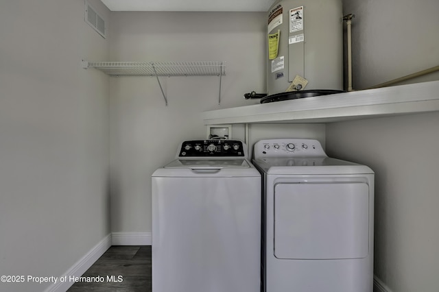laundry room with water heater, independent washer and dryer, baseboards, and wood finished floors