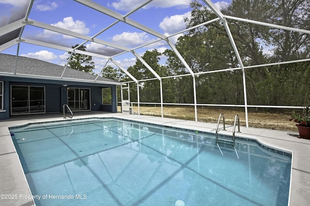 outdoor pool featuring a patio area and glass enclosure