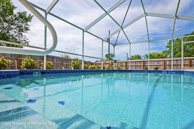 view of pool with a fenced in pool, a fenced backyard, and a lanai