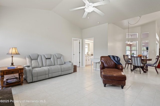 living room with ceiling fan, high vaulted ceiling, and light tile patterned floors
