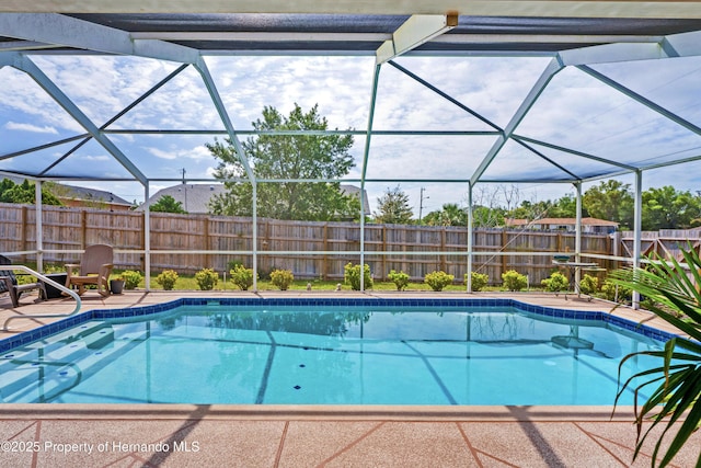 view of pool featuring glass enclosure, a fenced in pool, and a fenced backyard