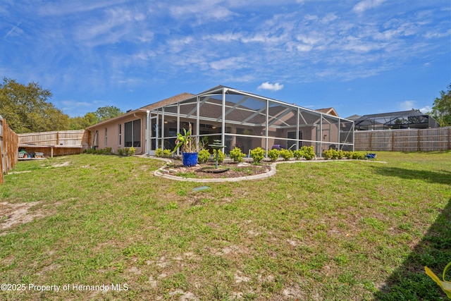 back of property featuring a fenced backyard, a lanai, and a yard