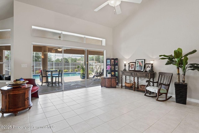 living area with a sunroom, ceiling fan, high vaulted ceiling, and tile patterned floors