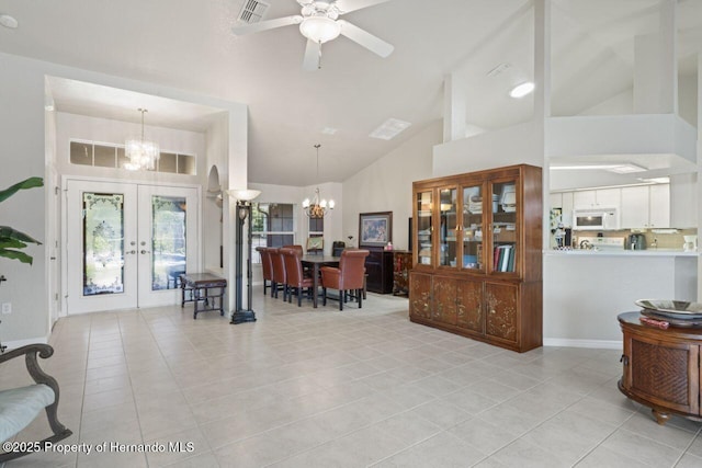 entrance foyer with visible vents, french doors, light tile patterned floors, and ceiling fan with notable chandelier
