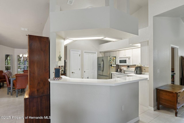 kitchen with white appliances, a notable chandelier, high vaulted ceiling, and light tile patterned floors