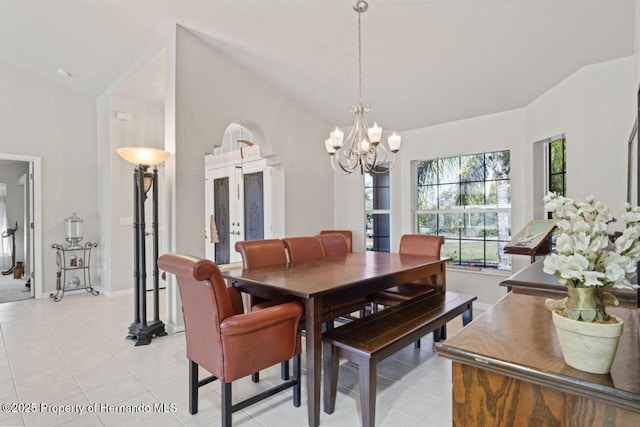 dining area featuring french doors, a chandelier, lofted ceiling, light tile patterned floors, and baseboards