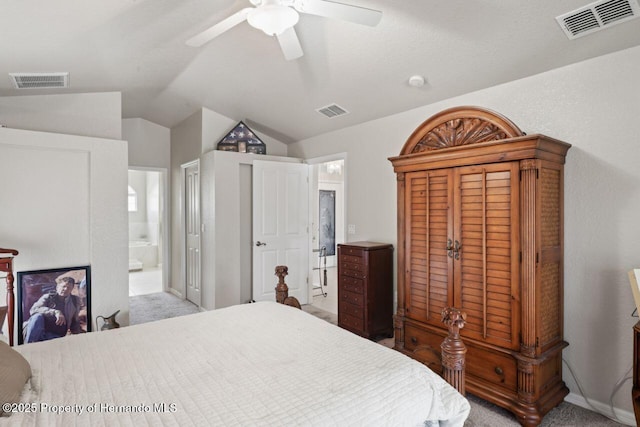 bedroom with ensuite bathroom, lofted ceiling, and visible vents