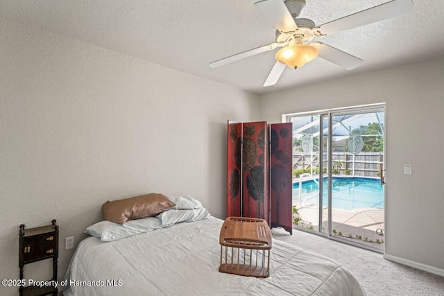 bedroom with carpet flooring, a textured ceiling, baseboards, a ceiling fan, and access to exterior