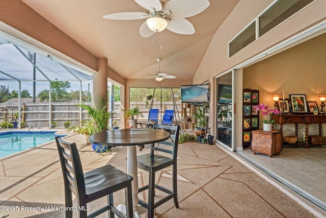 sunroom / solarium featuring high vaulted ceiling and ceiling fan