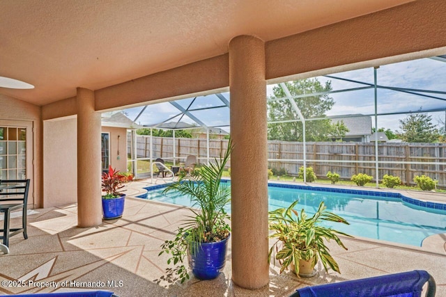 view of swimming pool featuring a fenced backyard, a fenced in pool, a lanai, and a patio