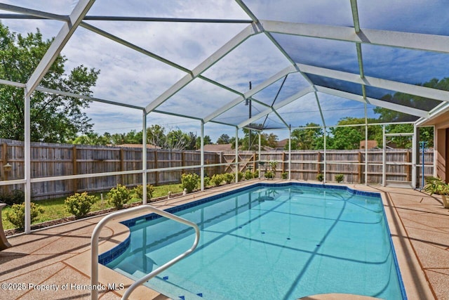 view of swimming pool with a fenced in pool, a fenced backyard, a lanai, and a patio area