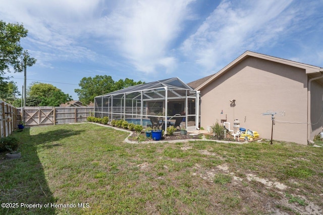 view of yard with a fenced backyard, a fenced in pool, and a lanai