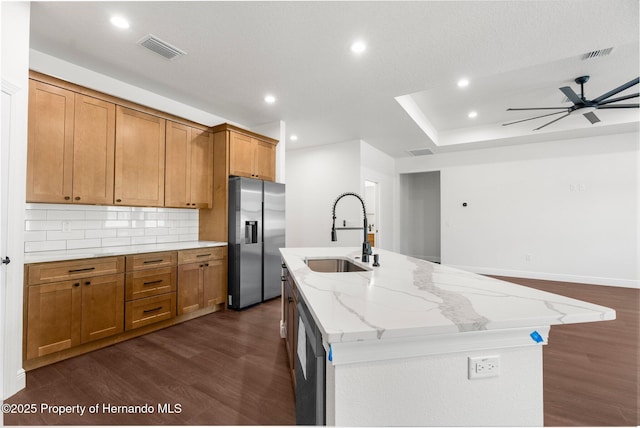 16043 Penn State Rd, Weeki Wachee, FL 34614 - kitchen with stainless steel fridge, a sink, dark wood-style floors, recessed lighting, and a kitchen island with sink