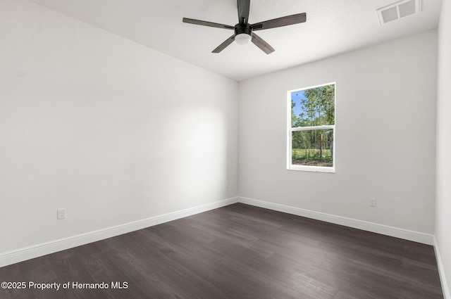 16043 Penn State Rd, Weeki Wachee, FL 34614 - empty room with dark wood-style floors, baseboards, and ceiling fan