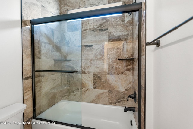 16043 Penn State Rd, Weeki Wachee, FL 34614 - bathroom with combined bath / shower with glass door and toilet