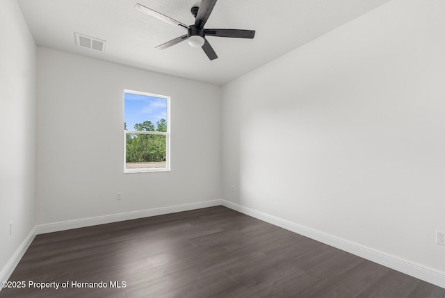 16043 Penn State Rd, Weeki Wachee, FL 34614 - spare room featuring dark wood-type flooring, baseboards, and a ceiling fan