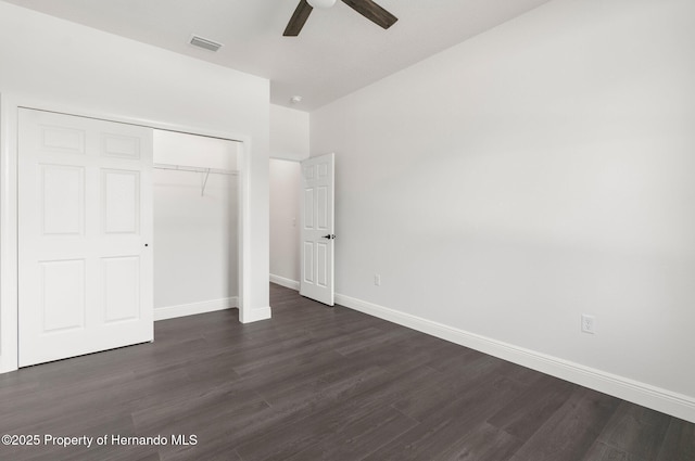 16043 Penn State Rd, Weeki Wachee, FL 34614 - unfurnished bedroom featuring baseboards, dark wood-style flooring, a closet, and ceiling fan