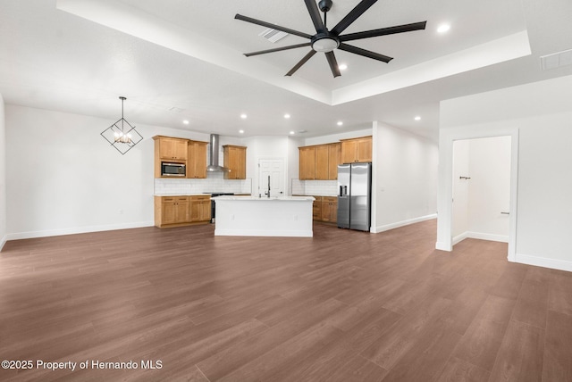 16043 Penn State Rd, Weeki Wachee, FL 34614 - unfurnished living room featuring a ceiling fan, recessed lighting, baseboards, dark wood finished floors, and a tray ceiling
