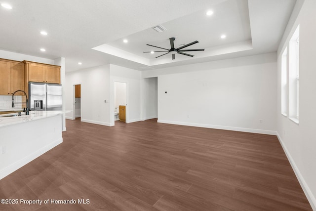 16043 Penn State Rd, Weeki Wachee, FL 34614 - unfurnished living room with a raised ceiling, a ceiling fan, recessed lighting, and dark wood-style floors