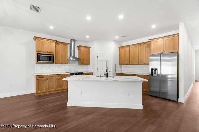 16043 Penn State Rd, Weeki Wachee, FL 34614 - kitchen featuring appliances with stainless steel finishes, wall chimney range hood, backsplash, a sink, and a center island with sink