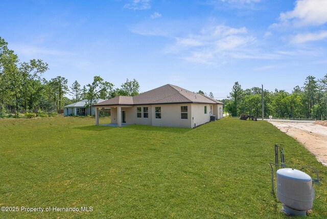 16043 Penn State Rd, Weeki Wachee, FL 34614 - back of property with a yard