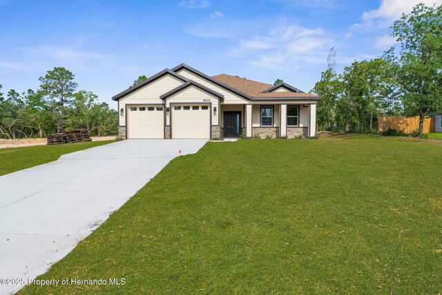 16043 Penn State Rd, Weeki Wachee, FL 34614 - craftsman house featuring concrete driveway, an attached garage, stone siding, and a porch