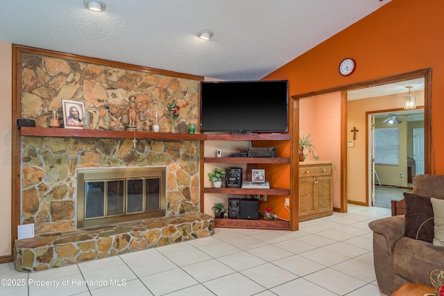 18216 Monteverde Dr, Shady Hills, FL 34610 - living room with light tile patterned flooring, a textured ceiling, vaulted ceiling, and a fireplace