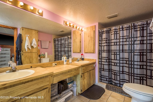 18216 Monteverde Dr, Shady Hills, FL 34610 - bathroom with toilet, a sink, tile patterned floors, and a textured ceiling