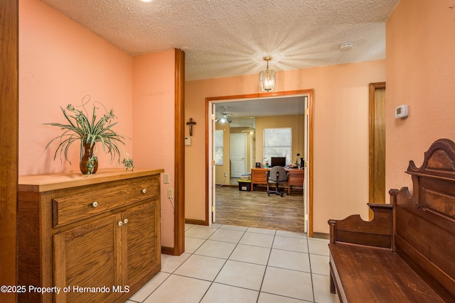18216 Monteverde Dr, Shady Hills, FL 34610 - hall featuring light tile patterned floors, baseboards, and a textured ceiling