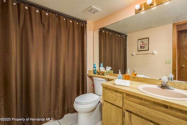18216 Monteverde Dr, Shady Hills, FL 34610 - bathroom with toilet, vanity, a textured ceiling, tile patterned flooring, and visible vents