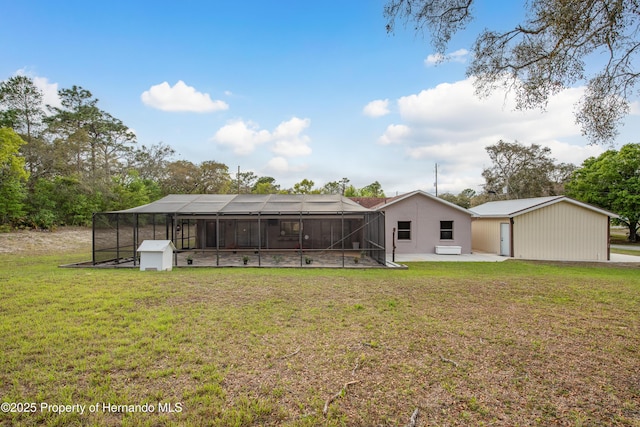 18216 Monteverde Dr, Shady Hills, FL 34610 - rear view of house with an outdoor structure, a lanai, stucco siding, a patio, and a lawn
