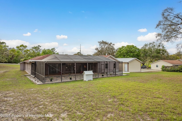 18216 Monteverde Dr, Shady Hills, FL 34610 - back of property featuring a lanai, an outbuilding, and a yard