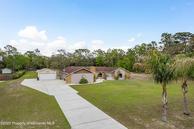 18216 Monteverde Dr, Shady Hills, FL 34610 - view of front of house featuring a front yard, concrete driveway, and a garage
