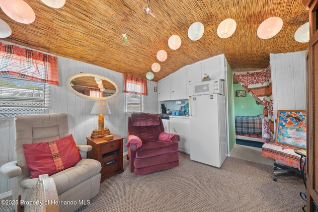 6448-2 W Richard Dr, Weeki Wachee, FL 34607 - living area featuring wood ceiling, vaulted ceiling, and carpet flooring