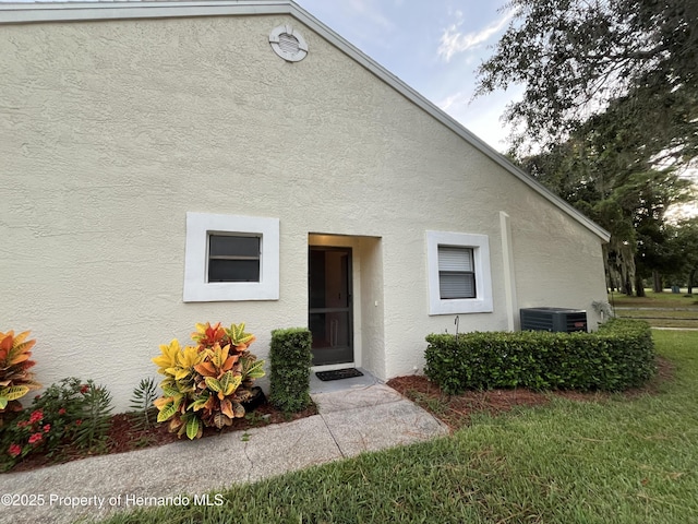 exterior space featuring stucco siding and central AC unit