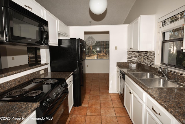 kitchen with white cabinets, a sink, black appliances, and backsplash