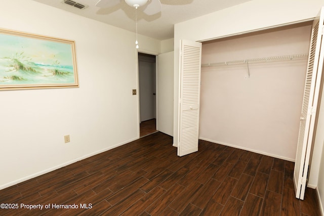 unfurnished bedroom featuring visible vents, a closet, baseboards, and wood finish floors